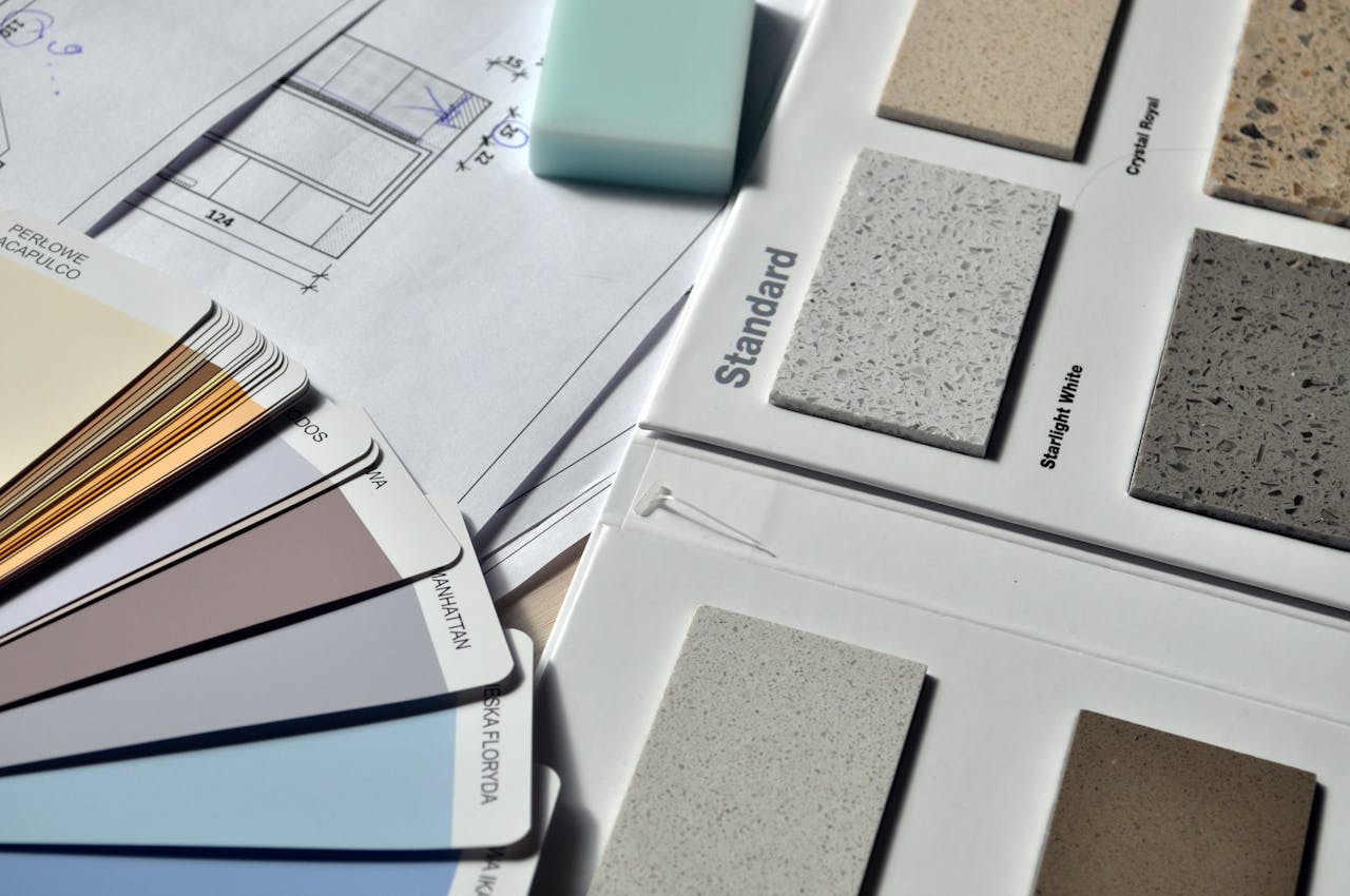 Home Color palette and material samples for interior renovation projects on a blueprint.